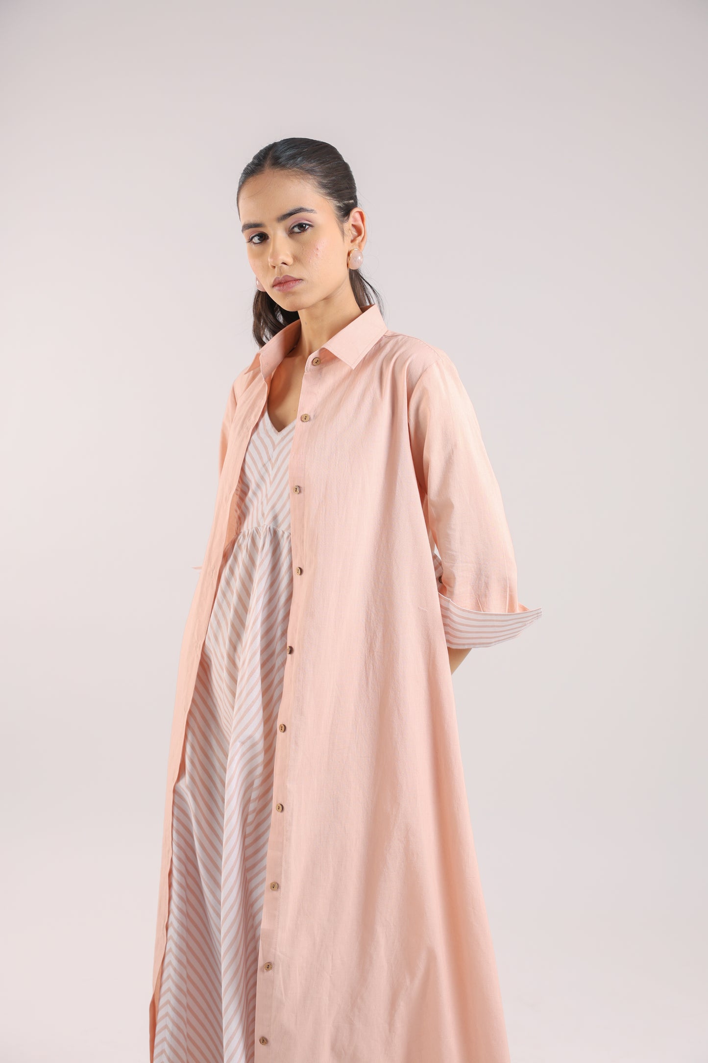 Nude Pink Shirt dress paired with a striped slip