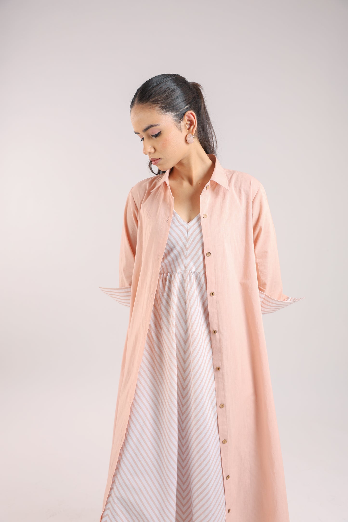 Nude Pink Shirt dress paired with a striped slip