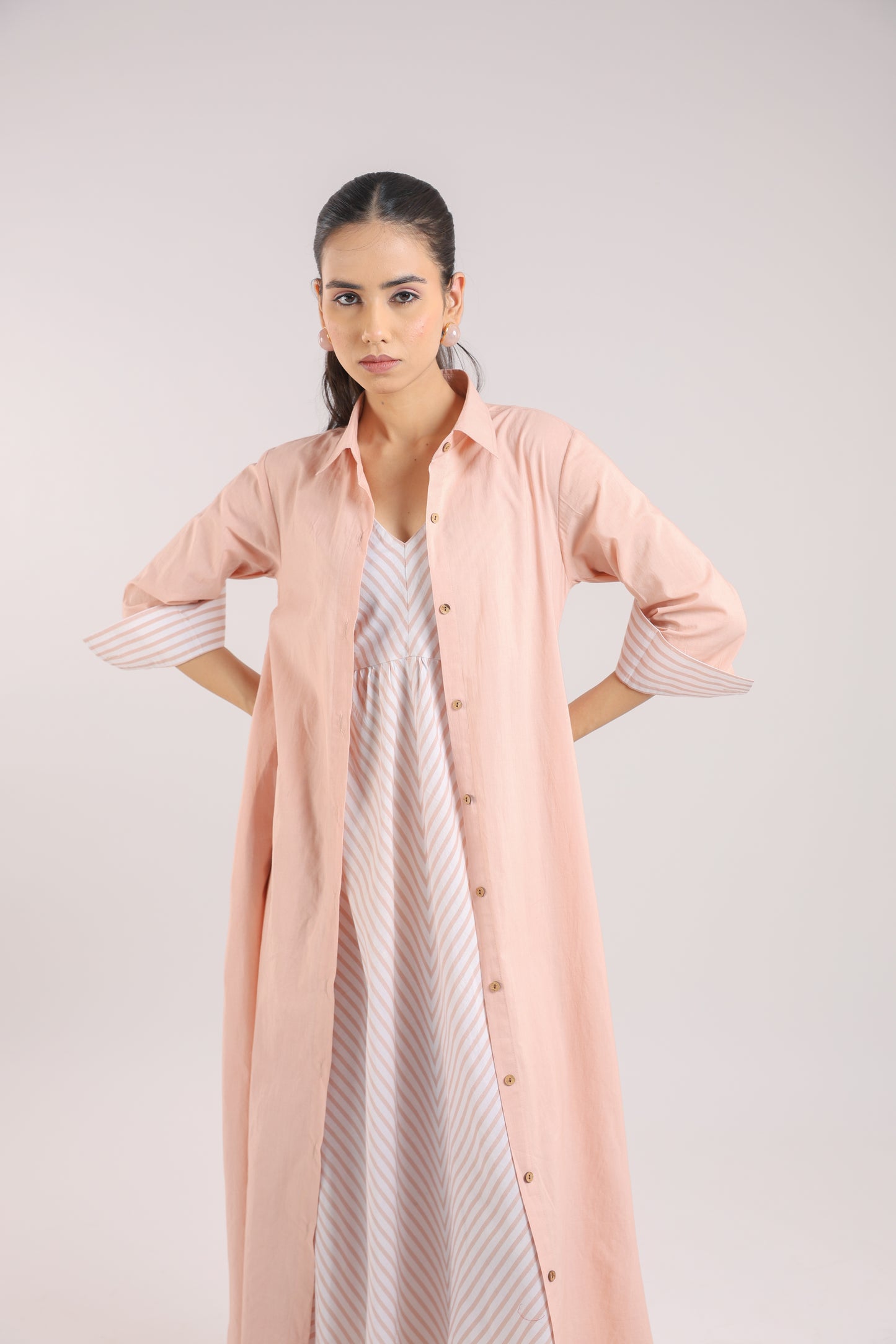 Nude Pink Shirt dress paired with a striped slip