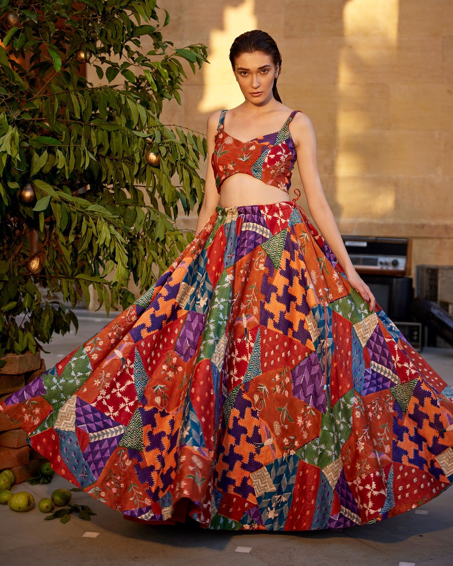 Burnt orange hand-block highlighted lehenga set paired with a blouse and dupatta for women