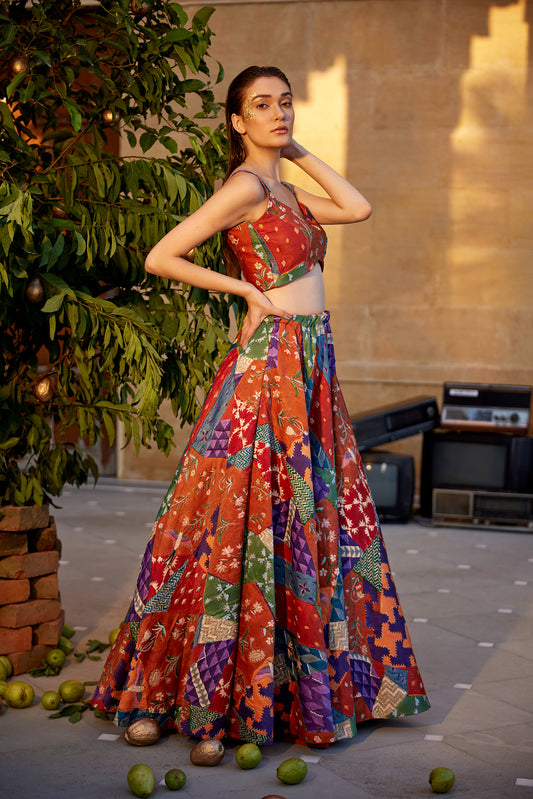 Burnt orange hand-block highlighted lehenga set paired with a blouse and dupatta for women