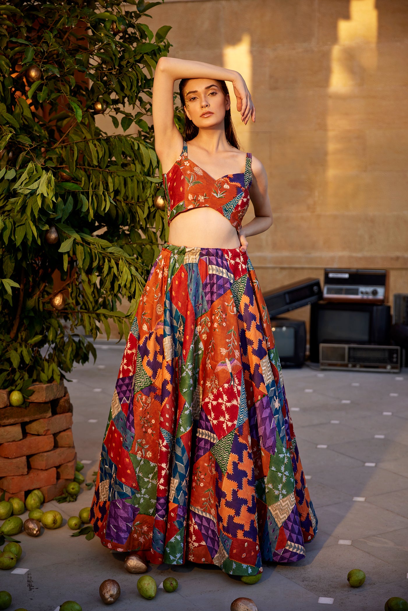 Burnt orange hand-block highlighted lehenga set paired with a blouse and dupatta for women