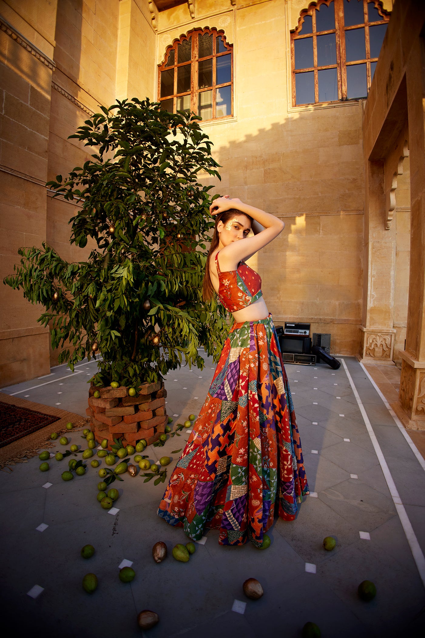 Burnt orange hand-block highlighted lehenga set paired with a blouse and dupatta for women