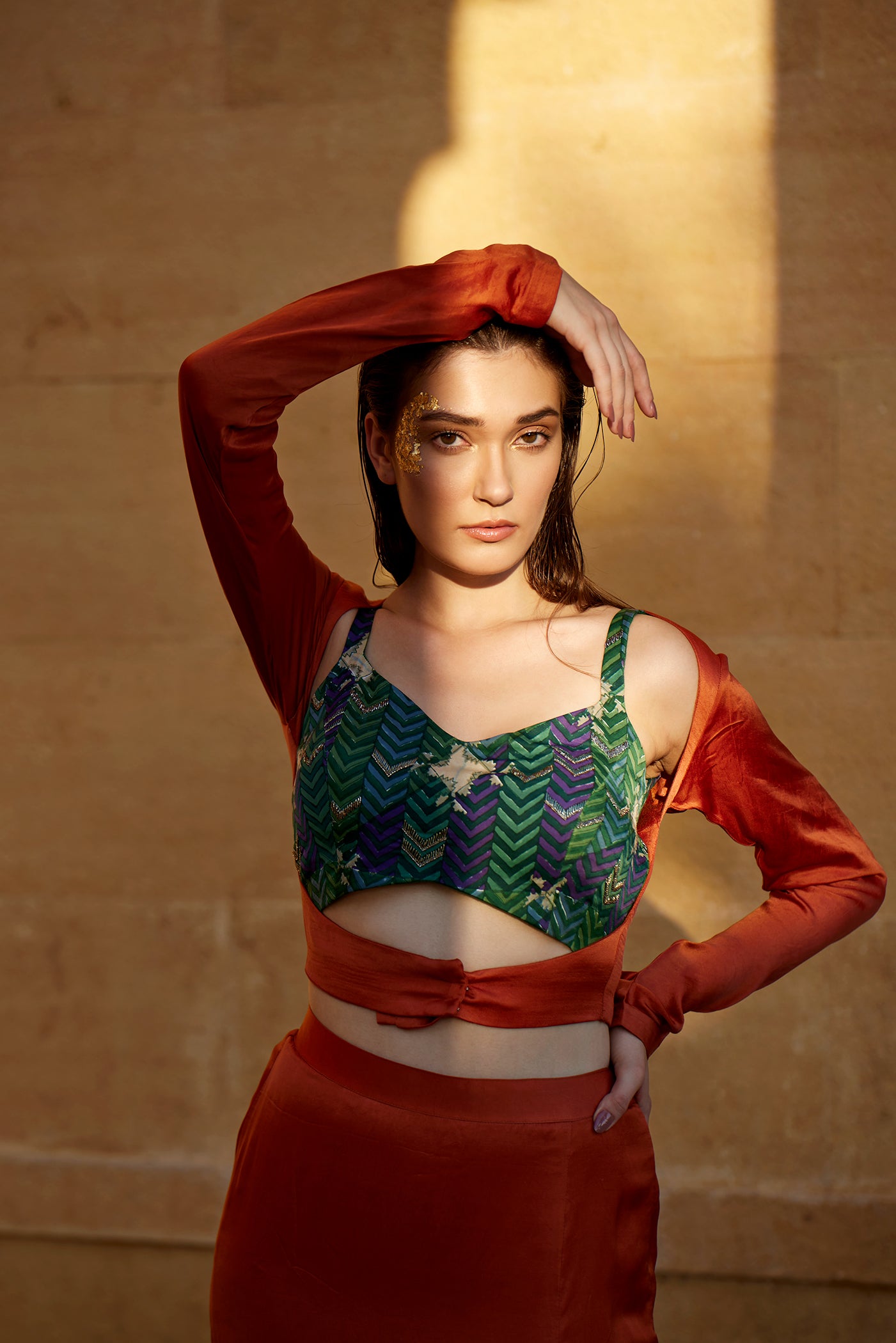 Burnt orange hand-block patched skirt paired with a jacket and highlighted blouse for women.