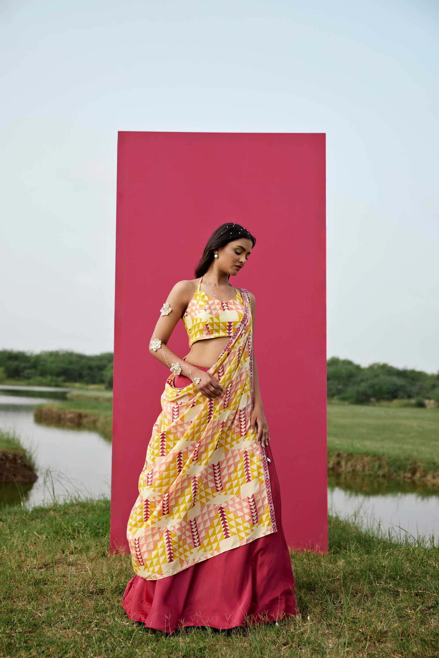 Yellow lehenga set paired with drape dupatta for women