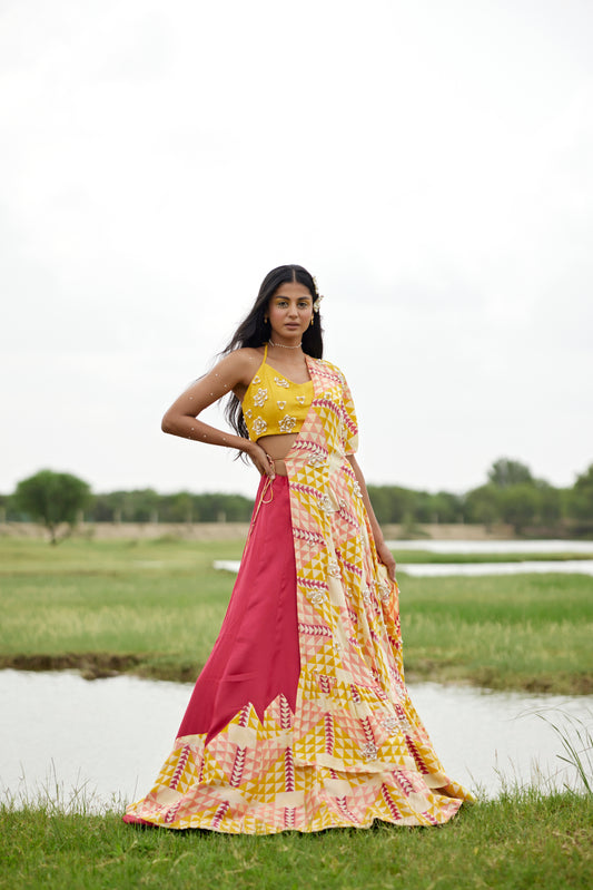 Yellow lehenga set with a patched hand-block border and a side tie detail on a highlighted cape for women