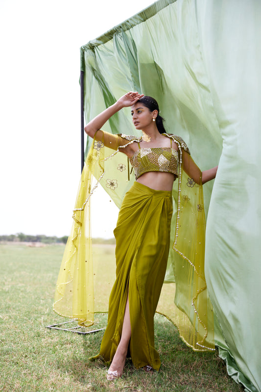 Satin green drape skirt paired with a chunky hand-embroidered blouse and a matching chunky embroidered cape in net for women