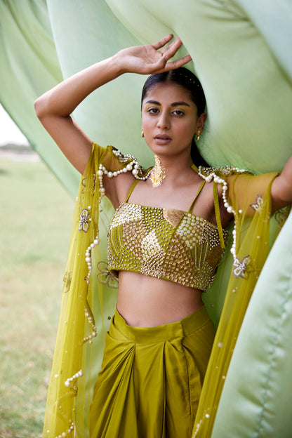 Satin green drape skirt paired with a chunky hand-embroidered blouse and a matching chunky embroidered cape in net for women