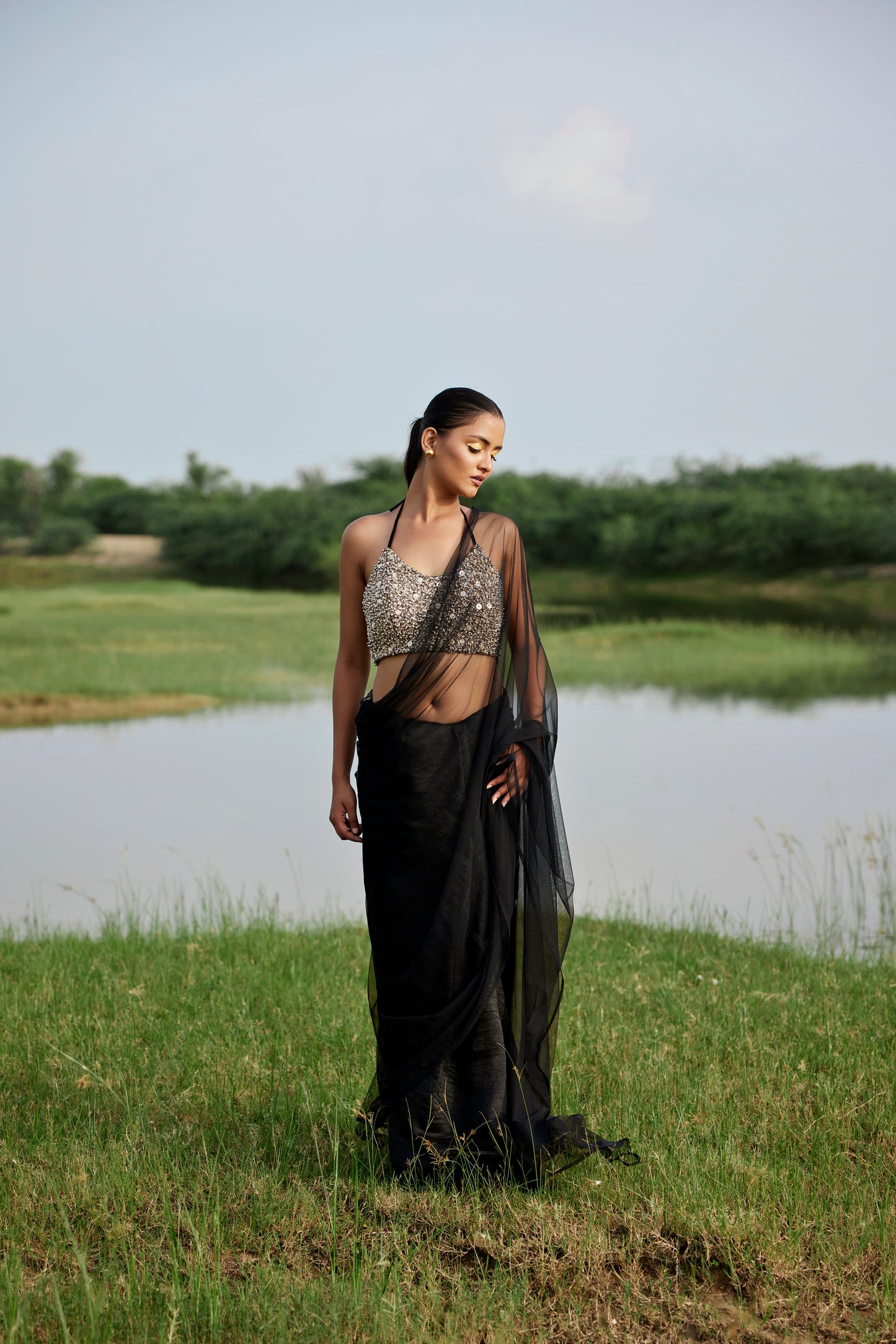 Kora silk & net half & half black saree paired with a heavily embroiderd blouse for women