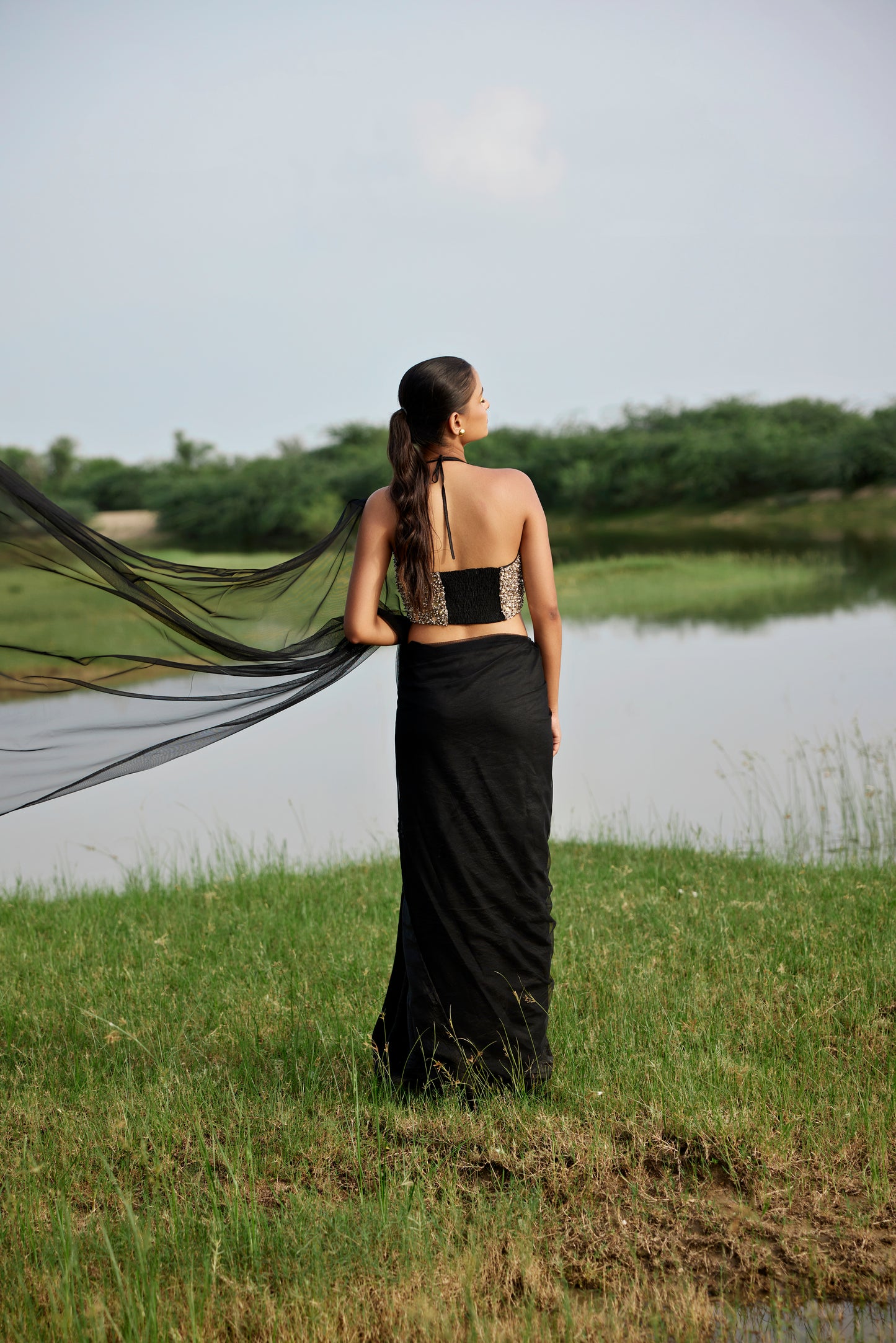 Kora silk & net half & half black saree paired with a heavily embroiderd blouse for women