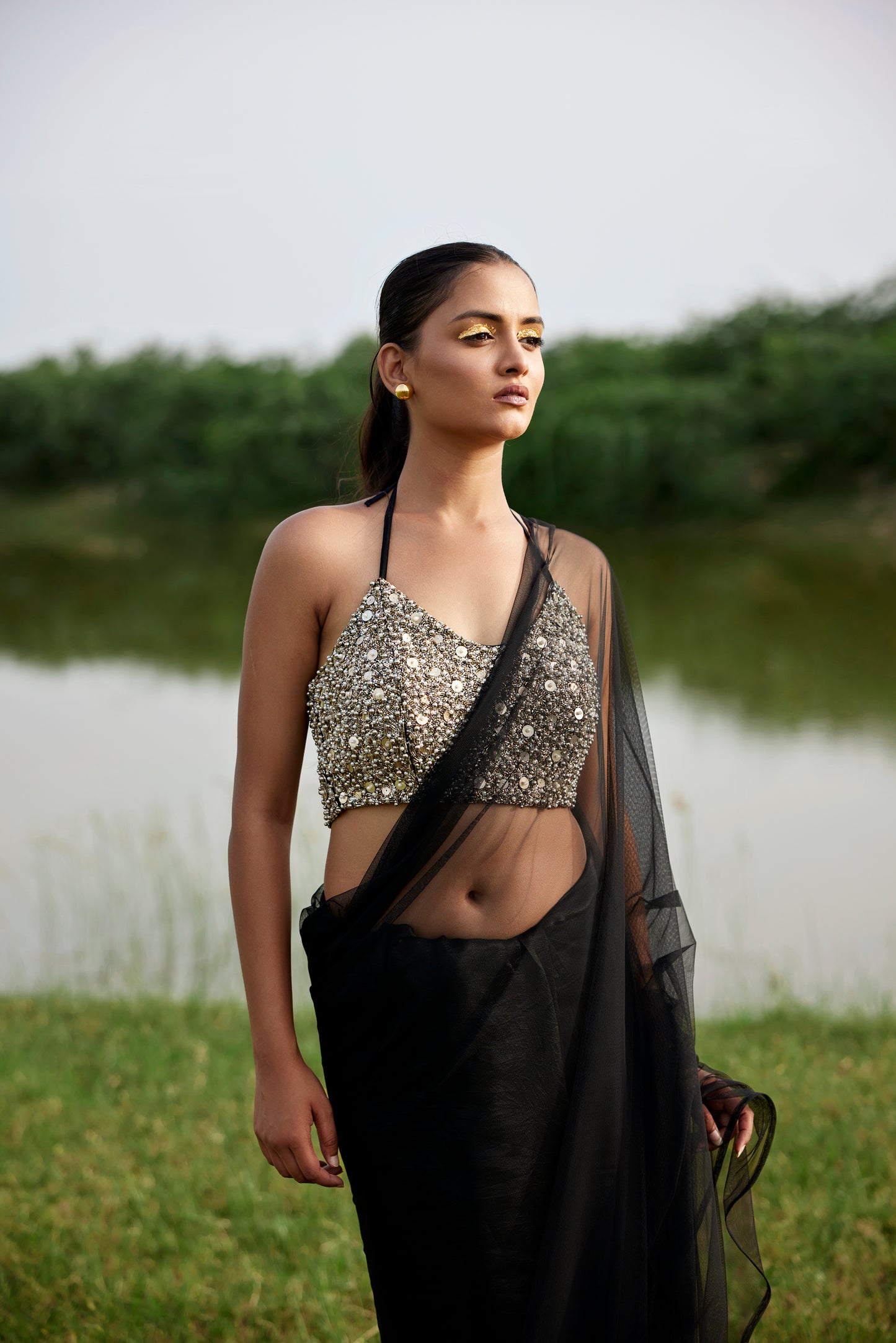 Kora silk & net half & half black saree paired with a heavily embroiderd blouse for women