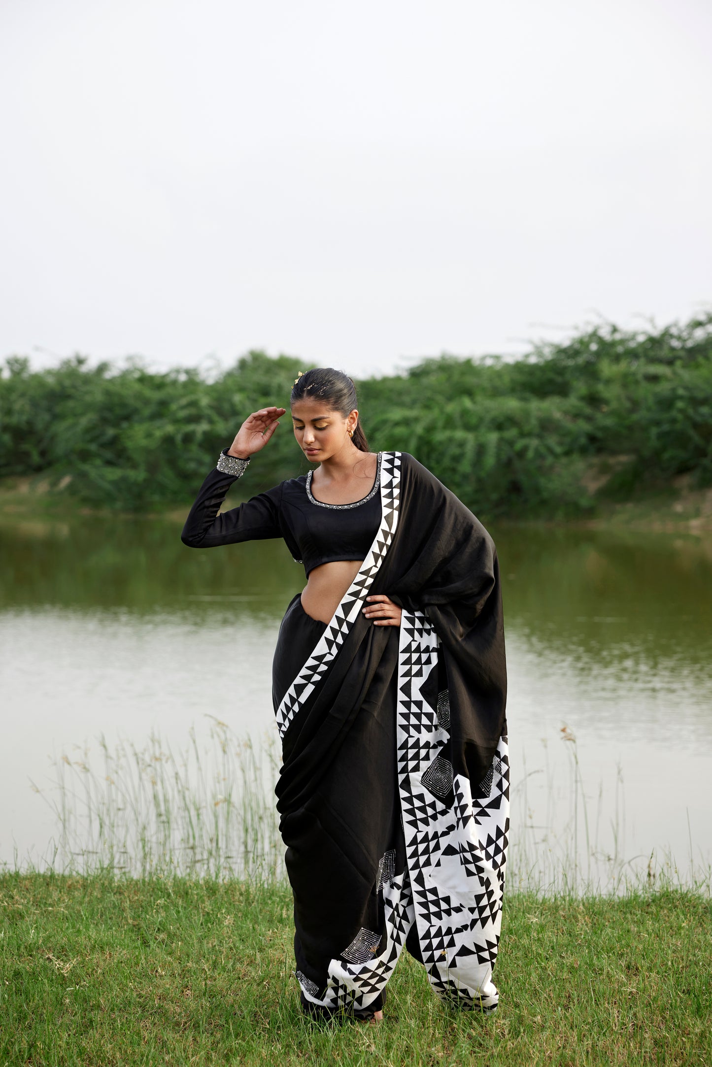 Black saree with patched handblock border paired with embroidered blouse for women