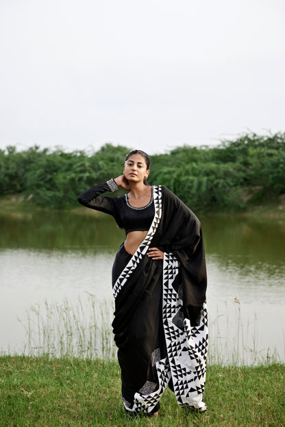 Black saree with patched handblock border paired with embroidered blouse for women