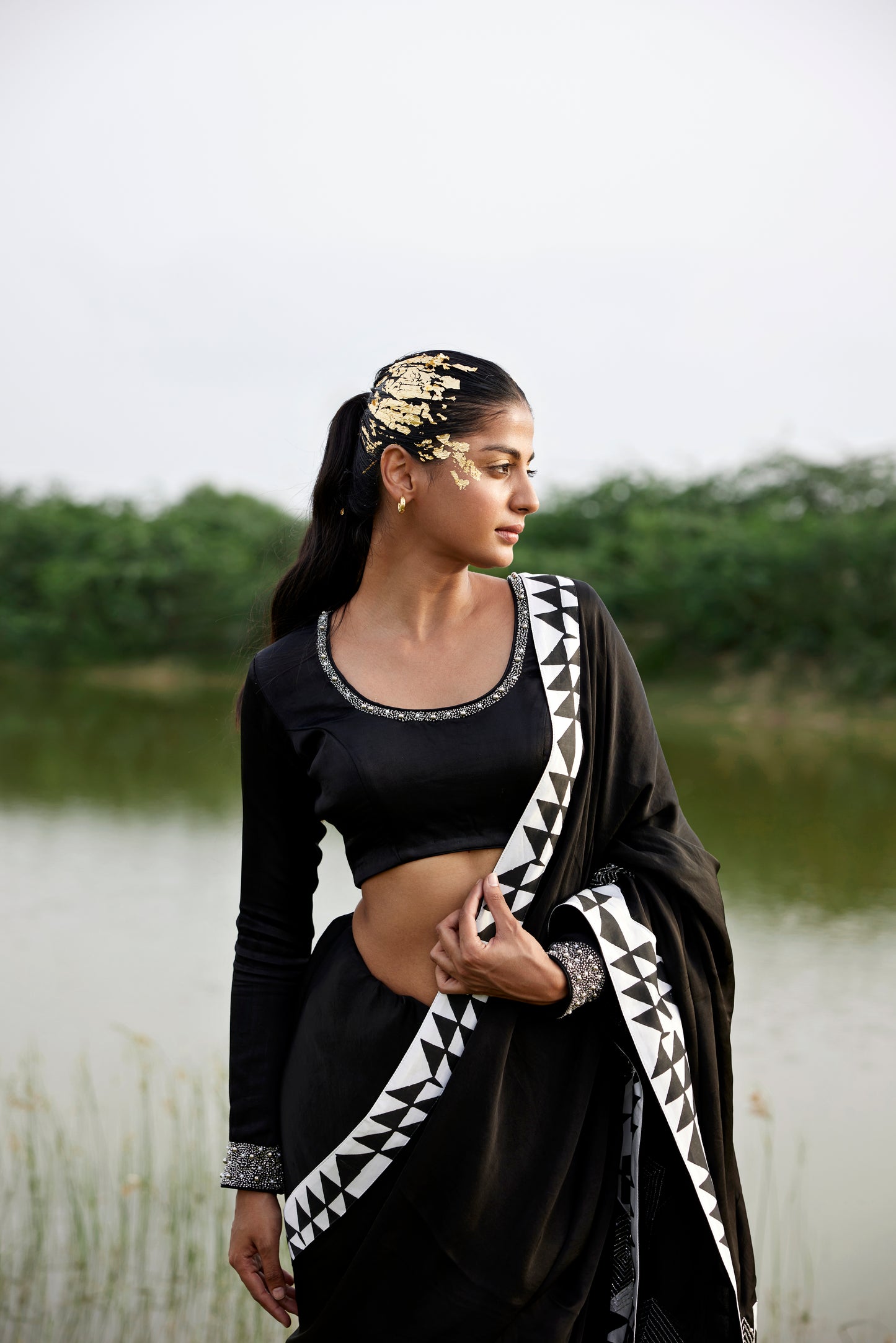 Black saree with patched handblock border paired with embroidered blouse for women