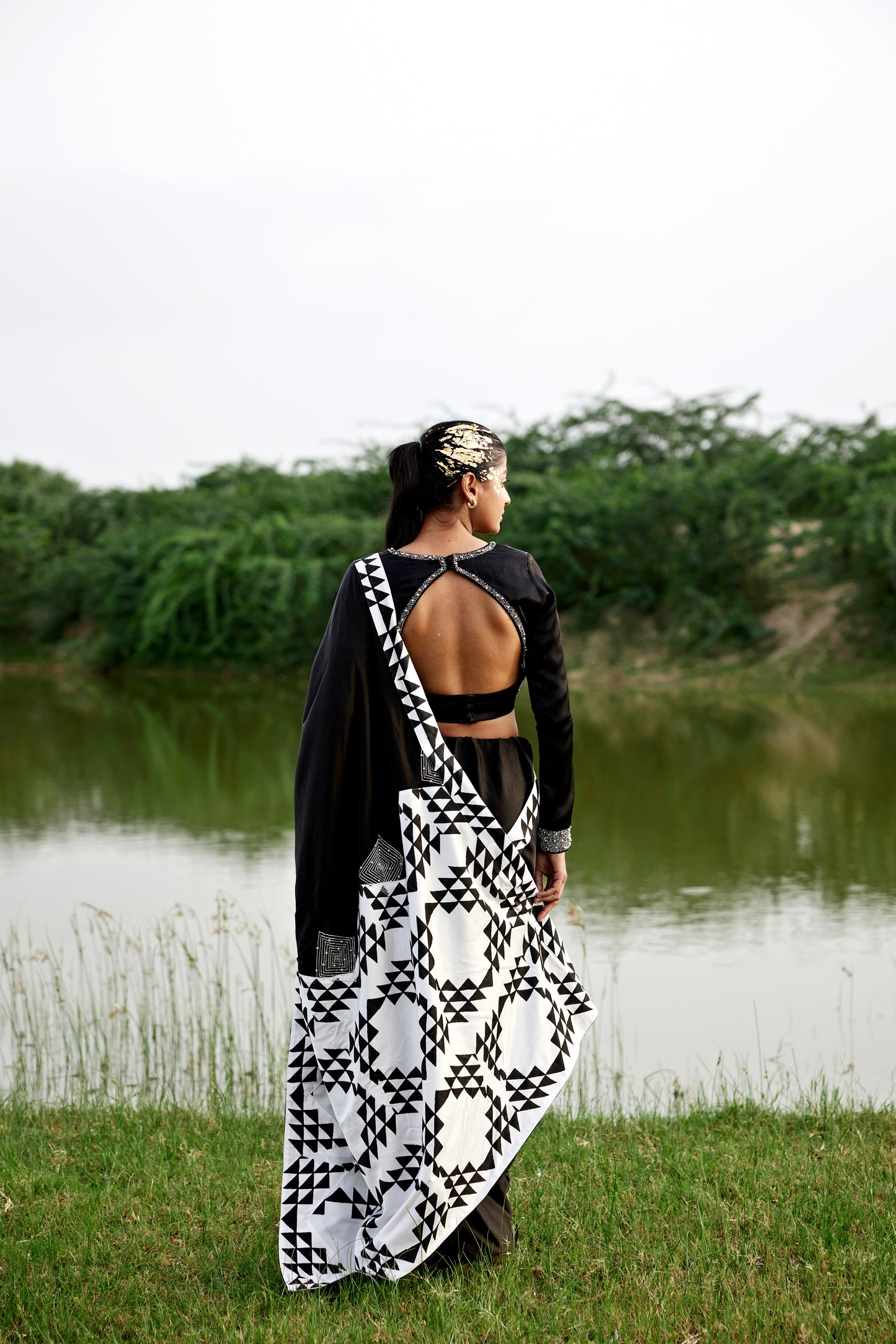 Black saree with patched handblock border paired with embroidered blouse for women